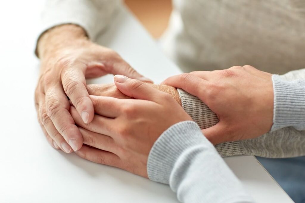 Holding a senior's hands