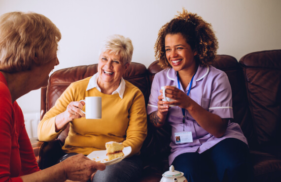 An assisted living nurse talking with some residents